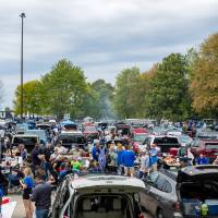 Overview picture of cars and people during Family Day tailgate.